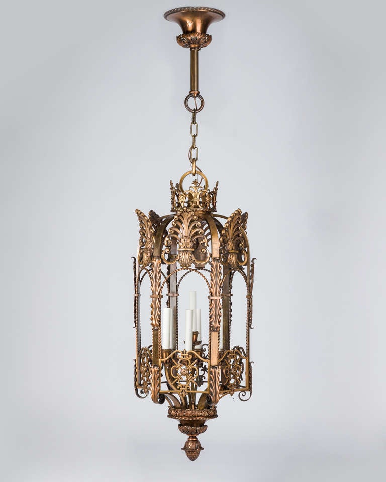 AHL3753

Circa 1920
A large Renaissance-style solid bronze hexagonal lantern in its original dark ruddy patina. Each of the six sides topped with an anthemion, having twisted wire, fleur-de-lis, and foliate details throughout, the whole topped with