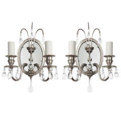 A Pair Of Oval Mirrored Sconces