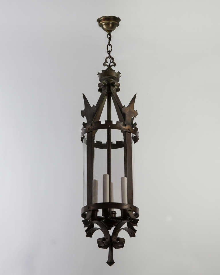 AHL3829

Circa 1910

An antique four-light lantern glazed with a clear cylinder lens, having crenelations, scrolls, and spear points. In its original age-worn brass finish. Due to the antique nature of this fixture, there may be some nicks or