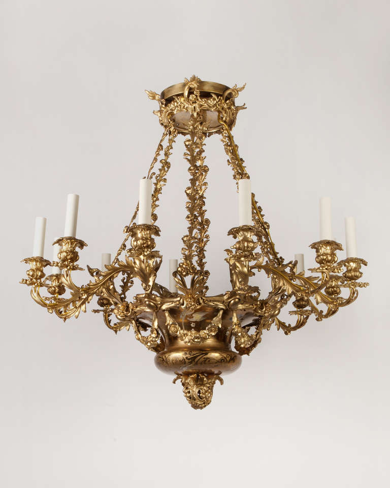 AHL3841
A vintage twelve light chandelier which retains its original gilded finish, enlivened by arabesques in bright and matte patterns native to the gilding, as well as polychrome foliate and aviary scenes. The fixture takes the form of a large