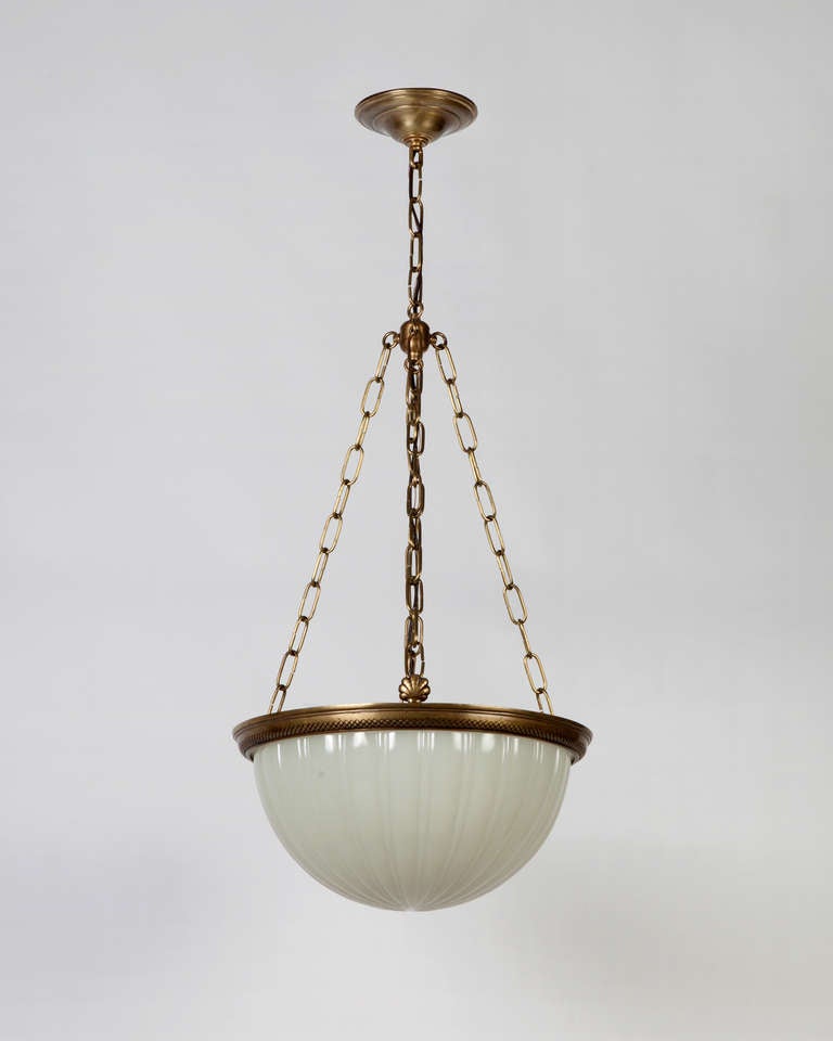AHL3842

An antique cast opaline glass and bronze chandelier with cast shell details over an abstracted rope patterned bezel. Due to the antique nature of this fixture, there may be some nicks or imperfections in the glass.
