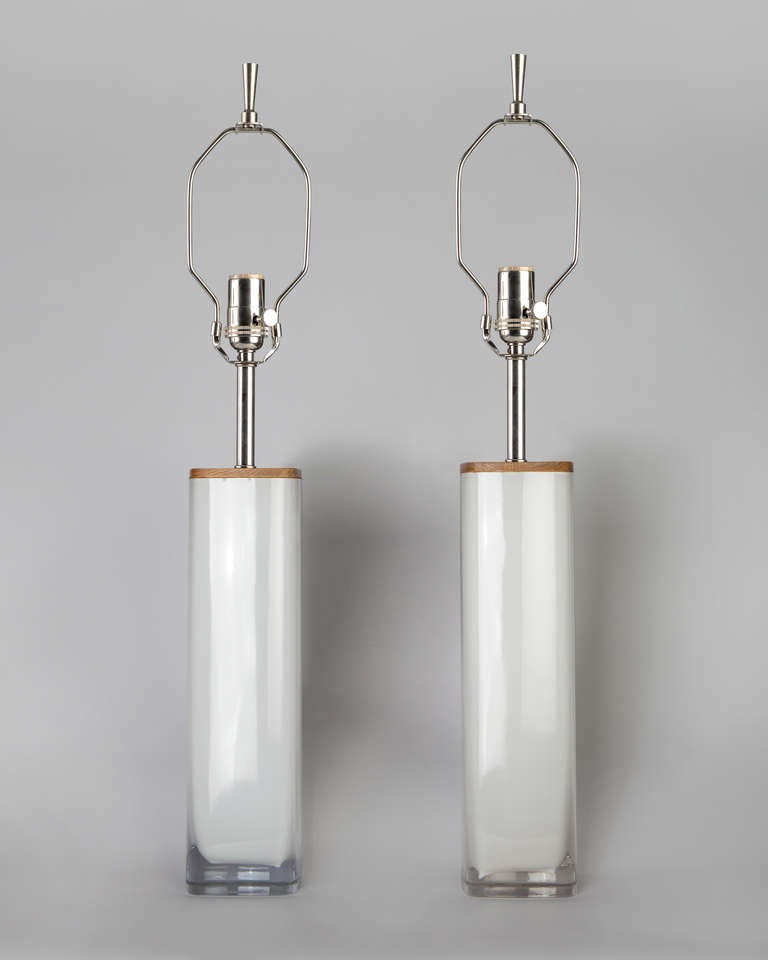 ATL1881
A pair of square white cased glass table lamps with wood and polished nickel fittings. Due to the antique nature of this fixture, there may be some nicks or imperfections in the glass. 

Dimensions

Overall: 27