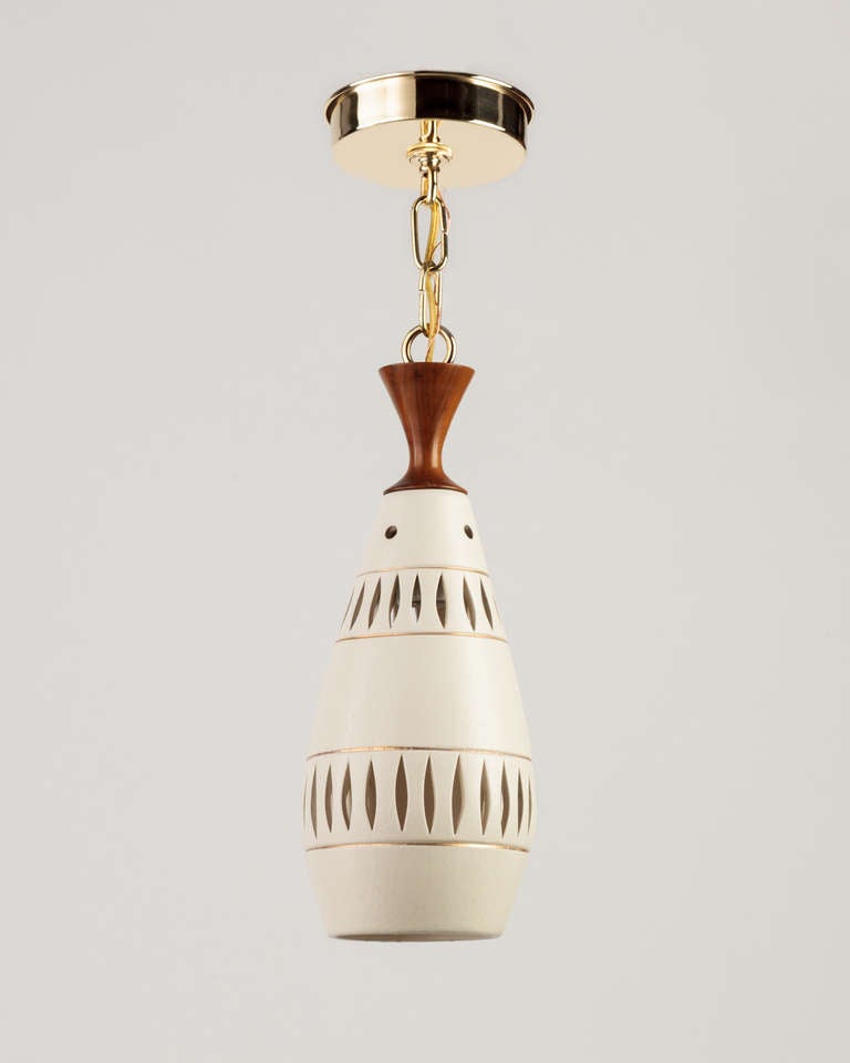 AHL3780

A vintage pendant with a pierced ceramic shade in a white glaze with gold lustre pinstripes on teak and polished brass fittings. Due to the antique nature of this fixture, there may be some nicks or imperfections in the ceramic as well as