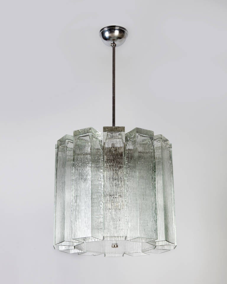 AHL3857

A vintage chandelier with textured clear rectangular glass on a chrome and nickel frame. Having a clear plastic bottom diffuser. Due to the antique nature of this fixture, there are some nicks or imperfections in the glass, including one