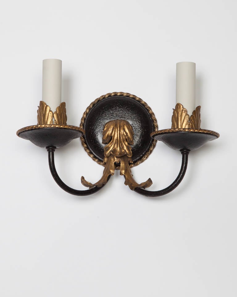 AIS2896

A pair of double-light sconces in their original black enamel finish. The rope-bordered bobeches and backplates as well as the foliate-detailed cups and armbacks highlighted with gold leaf.

Dimensions:
Overall: 7-1/4