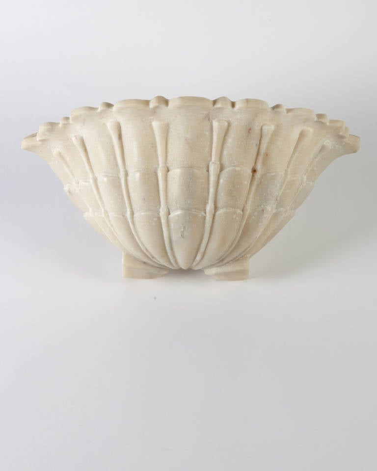 AIS2900.

A vintage carved white alabaster uplight shell sconce with light charcoal veining. Alabaster includes natural veining, as well as the marks and scuffs of age and use inherent in soft stone, giving the surface a wonderful, irreplaceable