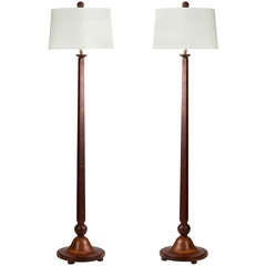 A pair of walnut floor lamps