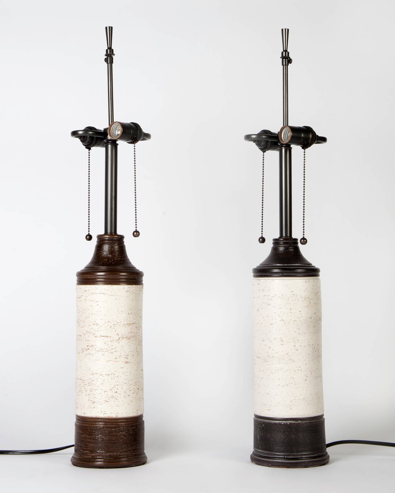 ATL1890.

A pair of Mid-Century Modern faux bois ceramic lamps glazed and textured to look like rustic birch trees. Having darkened brass fittings. Signed by the Swedish maker Bergboms; marked 