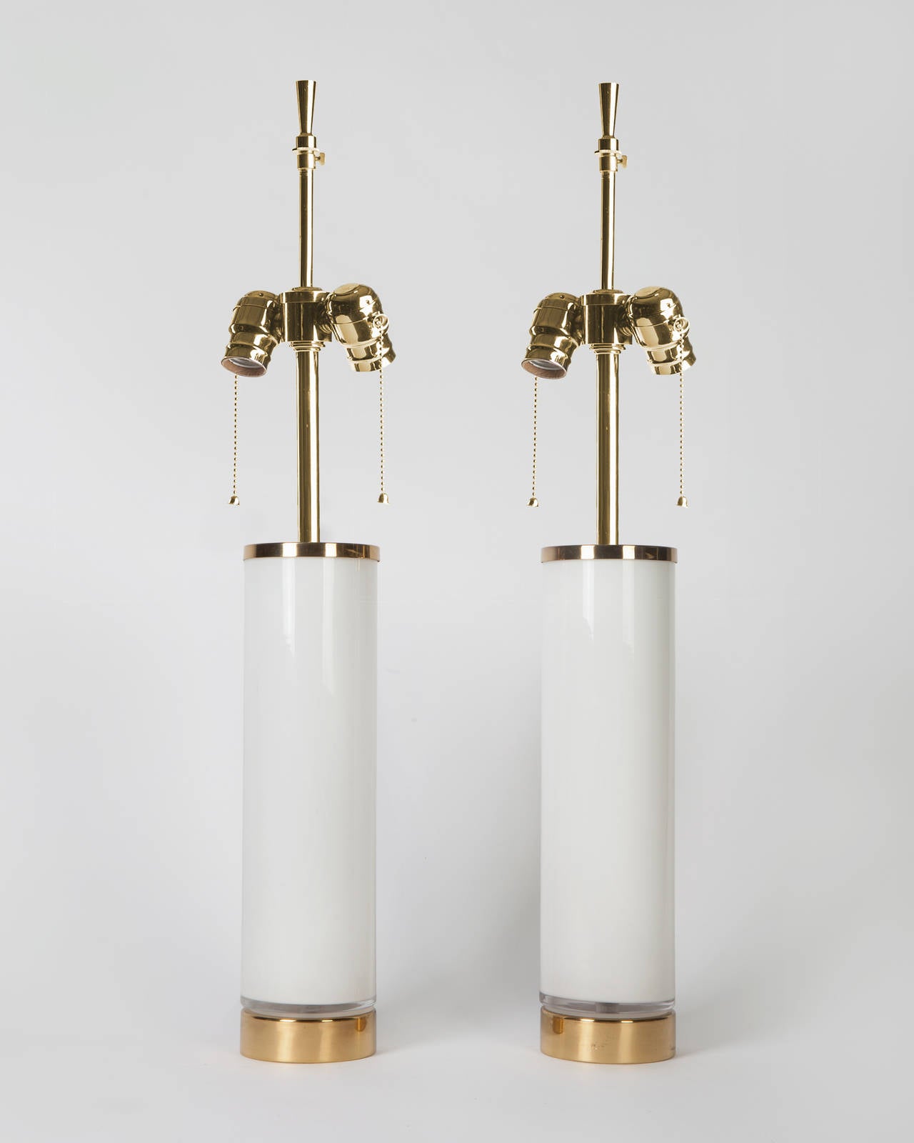 ATL1891

A pair of white cased glass cylindrical lamps with brass fittings attributed to the Swedish maker Bergboms. Due to the antique nature of this fixture, there may be some nicks or imperfections in the glass.

Dimensions:
Overall: 27-1/4