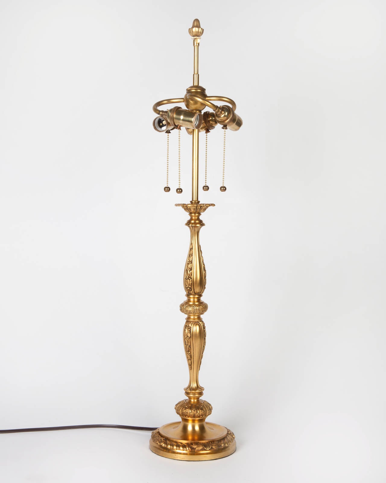 ATL1888
A slender baluster form table lamp detailed with bellflowers, rope-twists, and shells, in its original gilded finish. Signed by the New York maker Sterling Bronze Co.

Dimensions:
Overall: 32-3/4