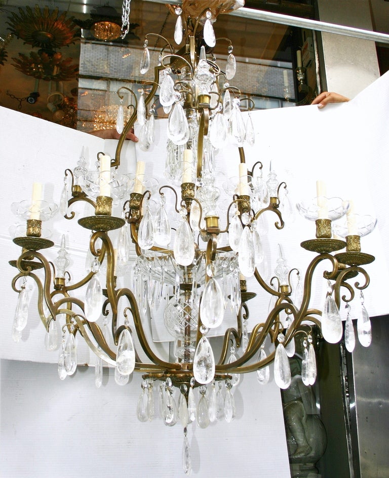 A large neo classic style rock crystal chandelier with 18 lights. The body made of patinated bronze and with rock crystal and crystal pendants.  Garnished with crystal spears.
61