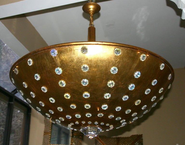 A pair of 1960's gilt metal light fixtures with crystal insets and 12 interior lights.  14