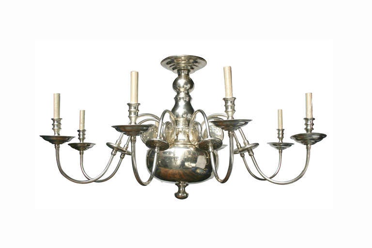 A silver plated, 8 lights Dutch chandelier. The arms with scrolling details and with oversized cups.
This chandelier could hang as close as 25