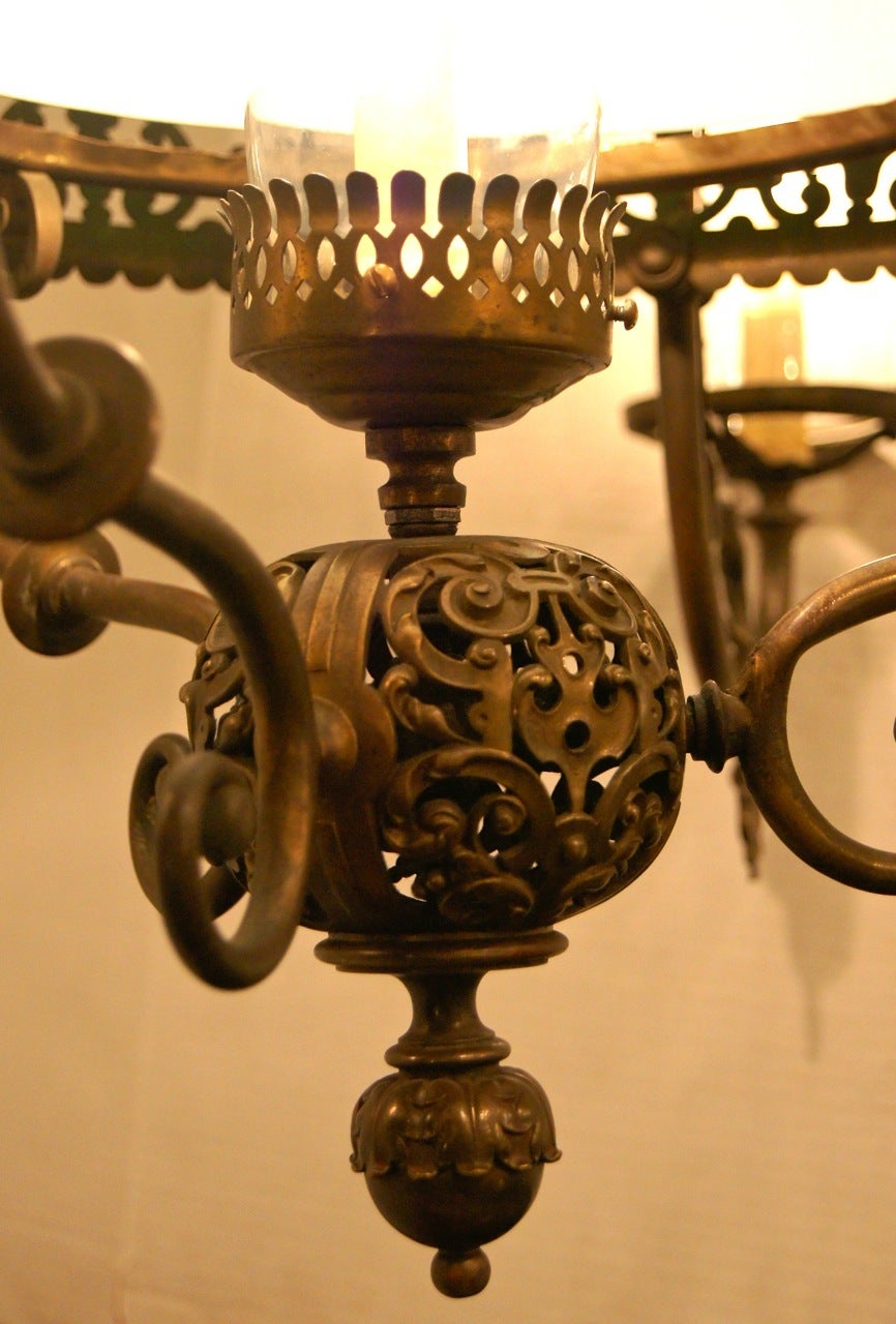 A late 19th century English cast bronze light fixture with glass shade and globes.