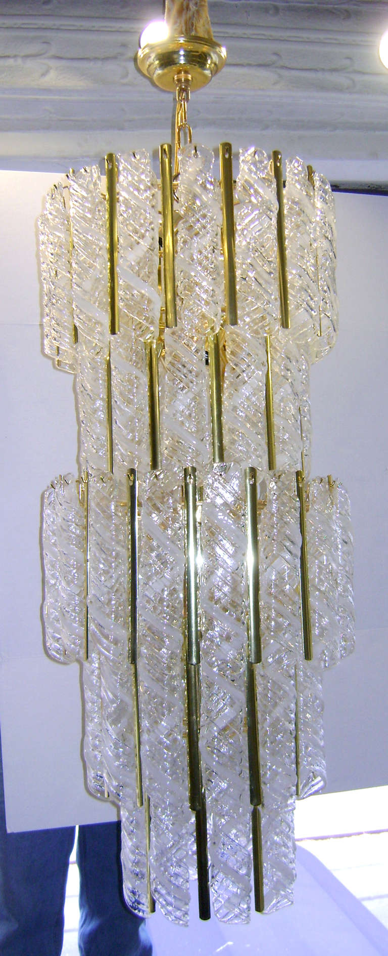 A circa 1960 Italian blown glass chandelier with 16 interior lights. Each individual glass piece in twirled design and with clear and white pattern.

Measurements:
Min. drop: 44