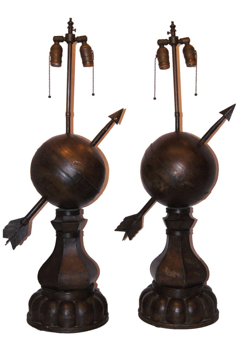 Pair of 1940s, French tole table lamps with an armillary globe and arrow on a pedestal base. Original patina.

Measures: 25