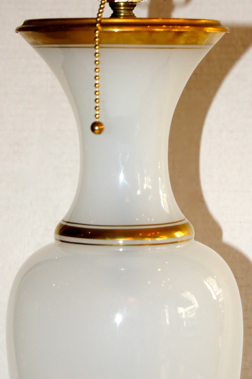 A circa 1920's French opaline glass table lamp with original gilt base.

Measurements:
Height of body: 18