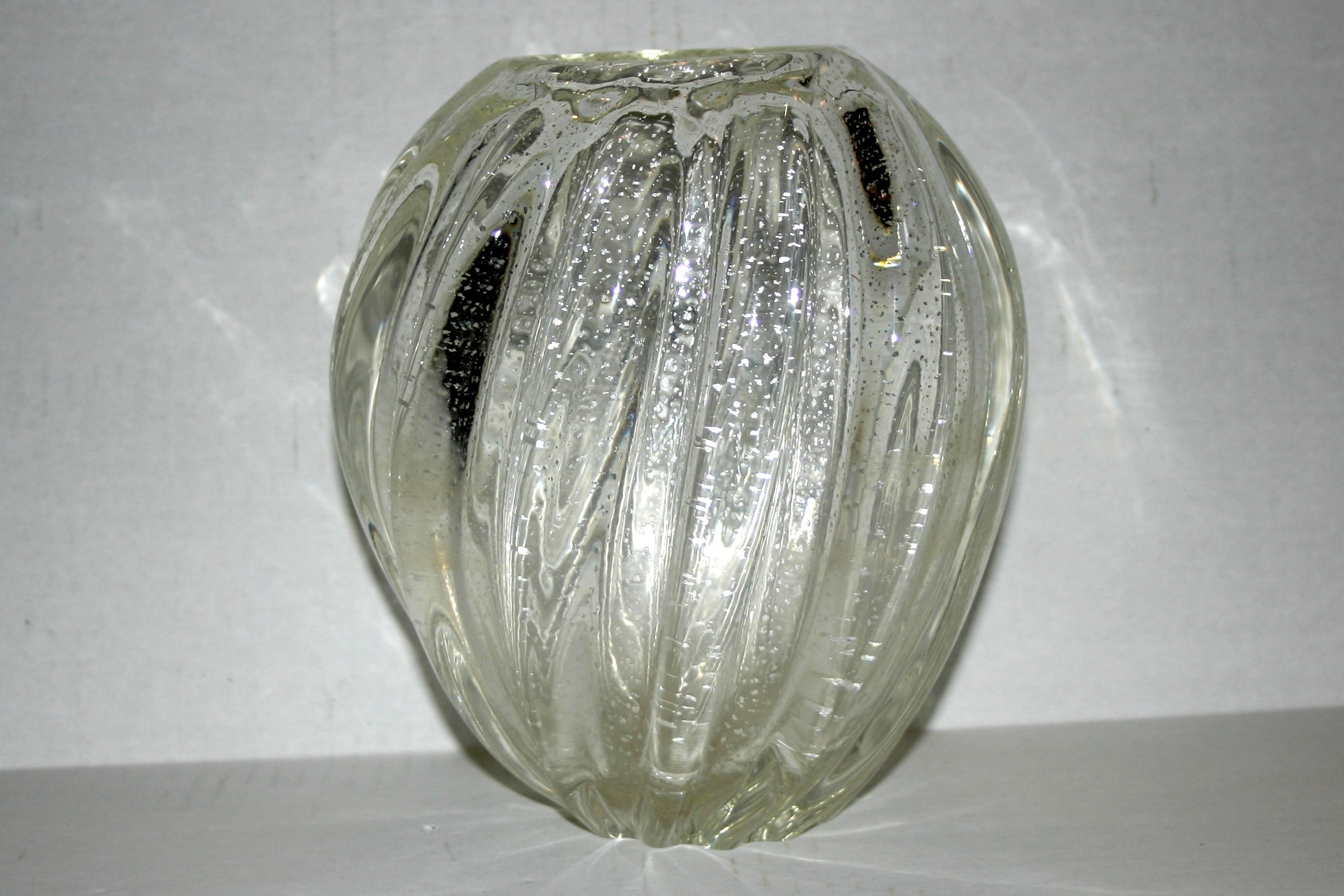 A 1940s Italian Murano glass vase with silver speckles in the glass, twisted tapered body.

Measurements:
Height 7