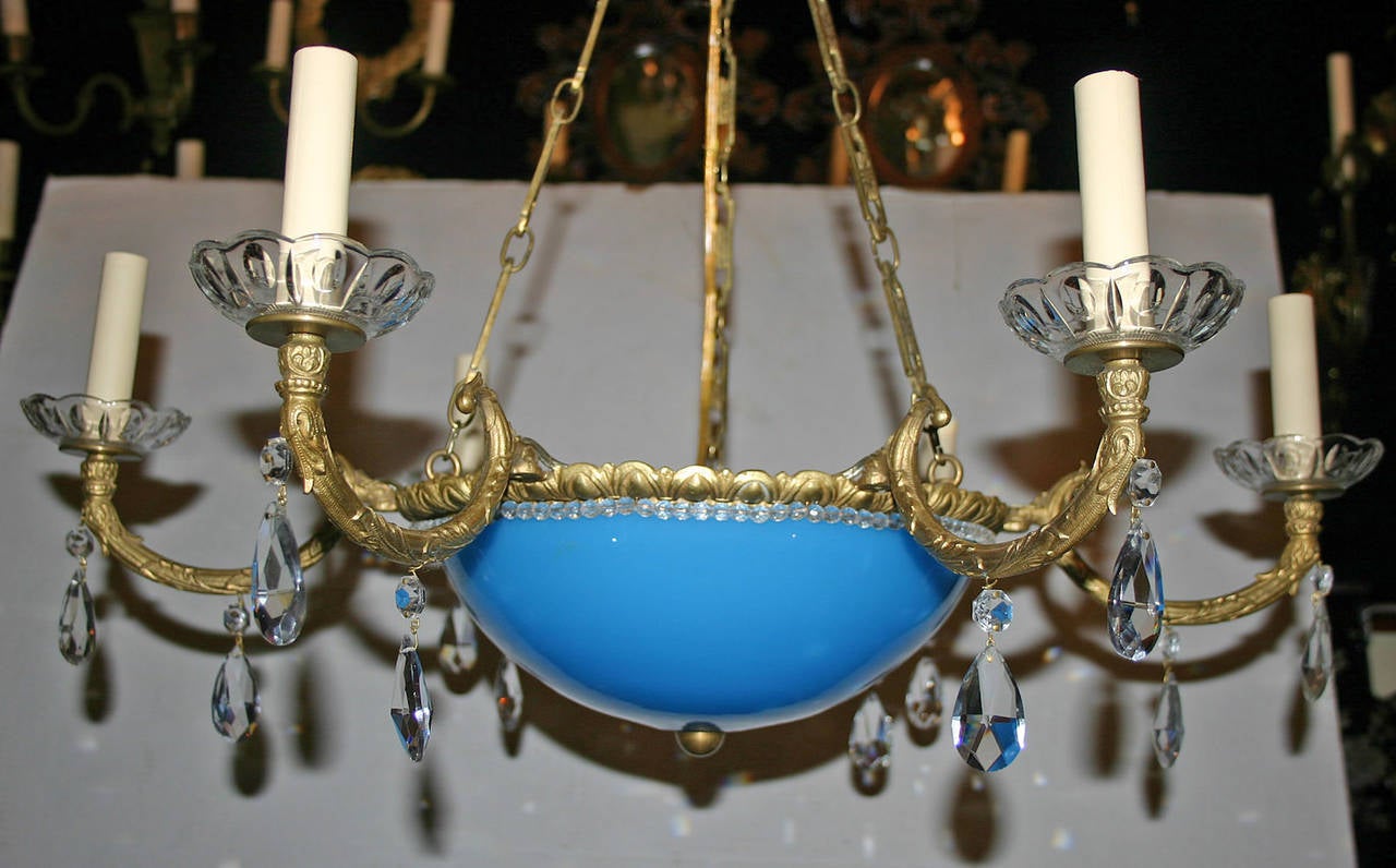 A French circa 1900 gilt bronze chandelier with crystal drops and beads and its original opaline glass inset. 
28 drop, adjustable
28