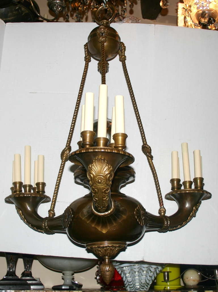 A unique late 19th century French bronze chandelier with original patina, a mercury glass ball the crowning body, rope-shaped supporting rods and three arms with a cluster of five lights each, 15 total. 

Measurements:
Diameter: 32