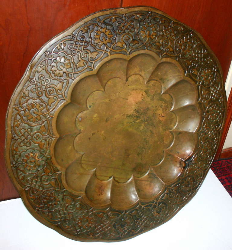 A late 19th century Turkish patinated brass wall mounted decorative tray with arabesque motif decoration. 

Measurements:
Diameter: 40.5