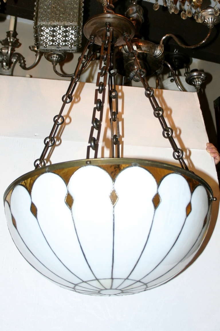 Circa 1920 English leaded glass light fixture with 4 interior lights. Amber and white glass body. 8