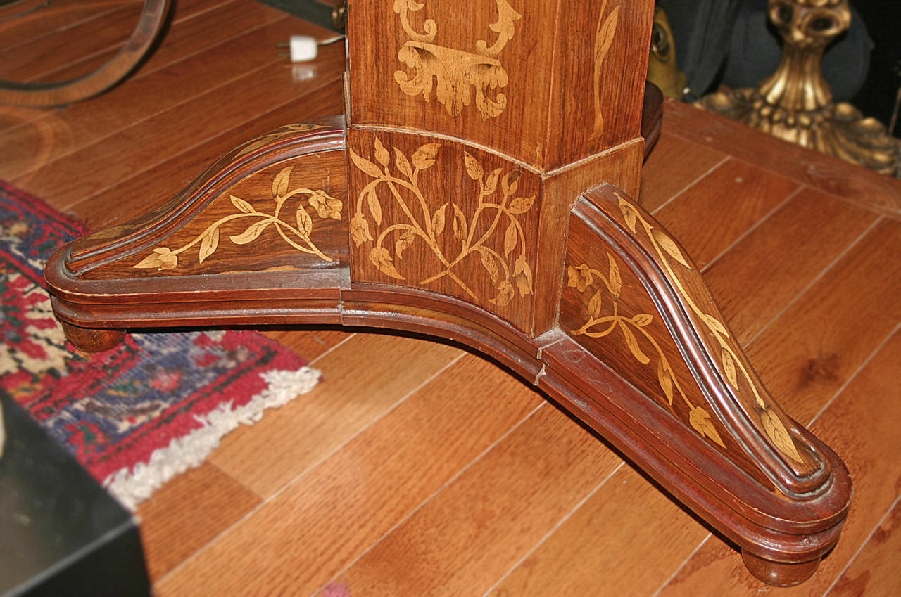 A late 19th century Italian marquetry table with pedestal base.

Measurements:
Height: 32