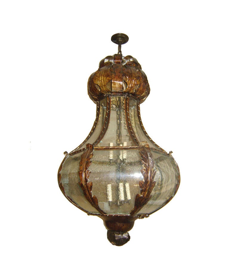 Pair of Venetian lanterns with bent glass panels, patinated metal body with foliage motif, circa 1900.
Eight interior lights each (could have up to 12 lights).
 