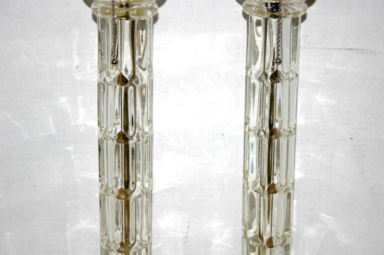 A pair of circa 1940's French molded glass table lamps with marble bases.  

Measurements:
Height of body: 16