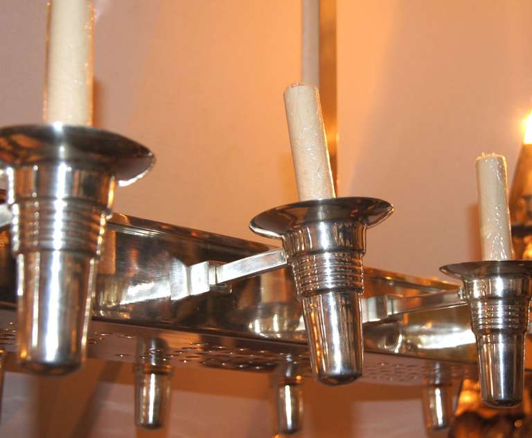 A circa 1950 Italian silver plated light fixture with 14 lights and 4 interior lights. Oversized rectangular canopy.

50