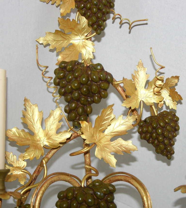 Pair of 1920s gilt bronze sconces with double arm. Original gilt bronze finish and painted grapes.

Measures: 14 1/4