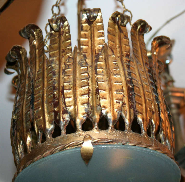A French gilt metal light fixture with glass inset and interior lights, circa 1930s.

Measurements:
Height: 17.5