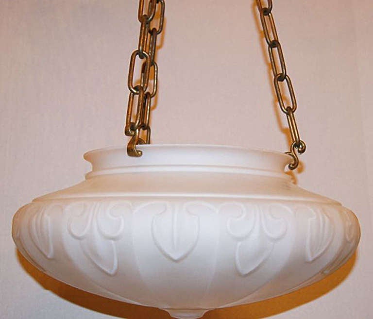 A circa 1920s American, neoclassic style molded glass opaline glass light fixture with foliage motif on body. Bronze chain and canopy. Three interior lights.

Measures: 16.5? diameter, 7? depth of bowl, 15? min. drop.