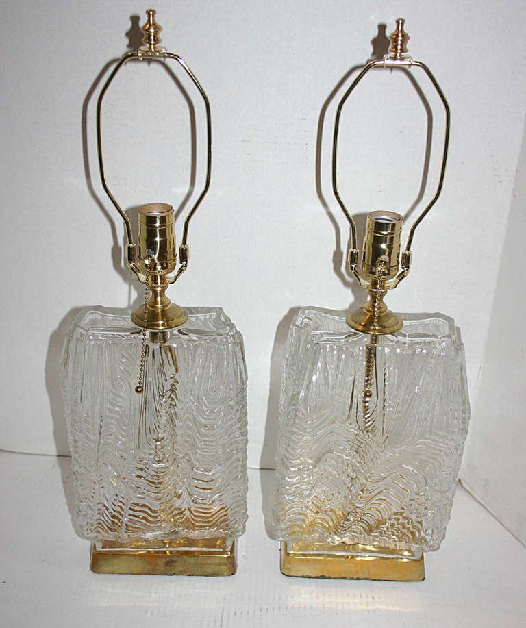 Pair of Swedish moderne style molded glass table lamps with gilt bases.

13