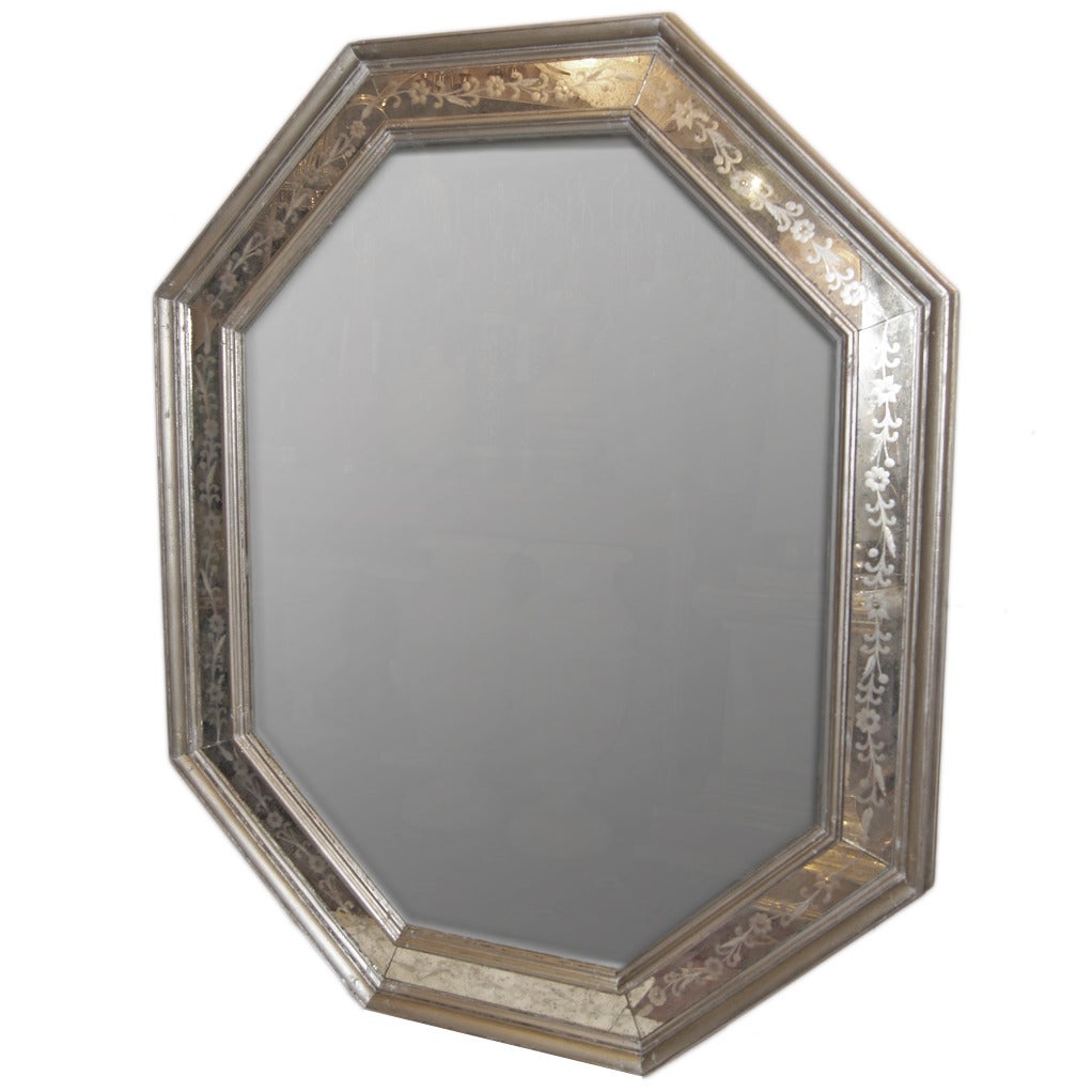 A pair of octagonal shaped Venetian mirrors with silver leaf frame, and with etched mirror details on frame. Etched mirror with foliage and floral motif. Sold individually.

Measurements:
53.5