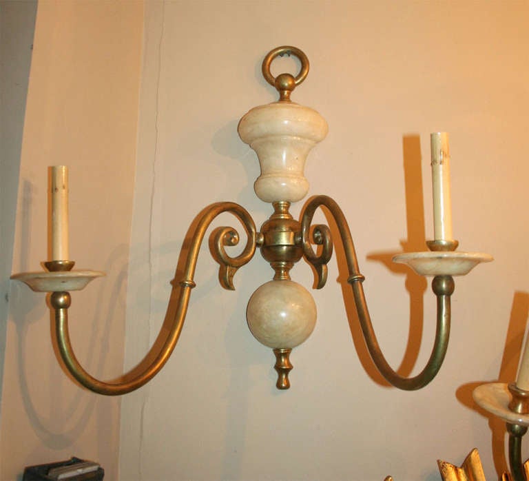 A pair of turn of 1940's Dutch style Italian alabaster and bronze sconces.

Height: 26