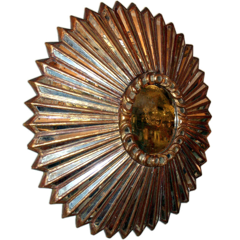 A late 19th century Spanish Colonial giltwood sunburst shaped mirror with mirror insets in frame. Original patina.
Measurents:
Diameter: 35.5