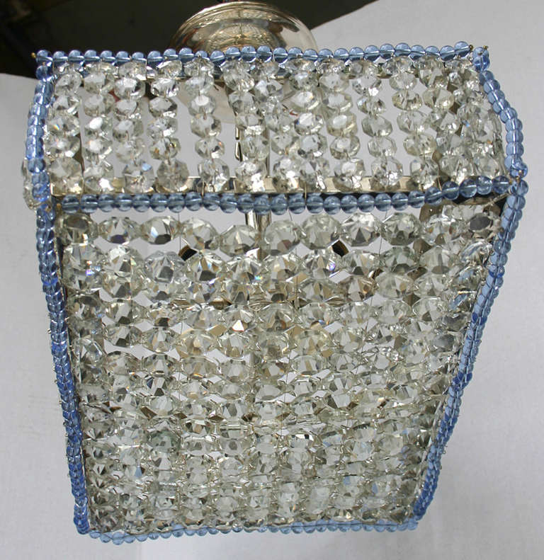 A pair of rectangular woven crystal light fixtures with blue beads details. Four candelabra interior lights.
Measures: 16.5 length, 11.25 width, 14.5