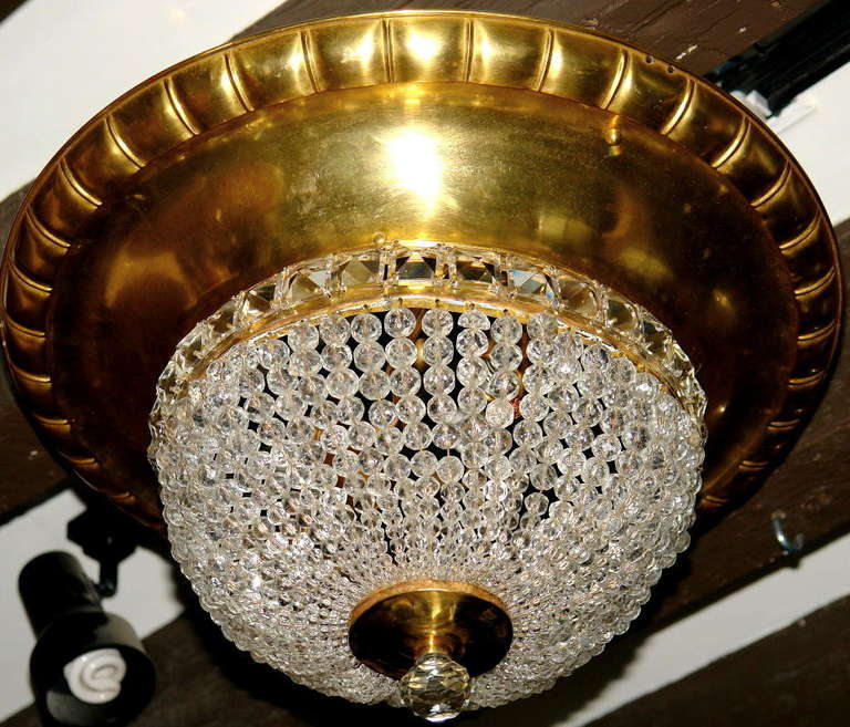A circa 1920s Italian gilt metal light fixture with crystal beads and interior lights.

Measurements:
Diameter: 20″
Drop: 11″