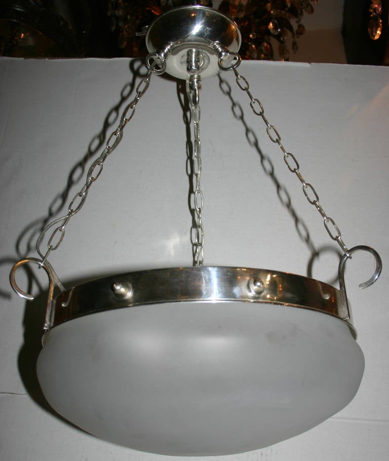 A set of 4 1940's French silver plated light fixtures with frosted glass insets. 3 interior lights each.

Measurements:
Drop: 21