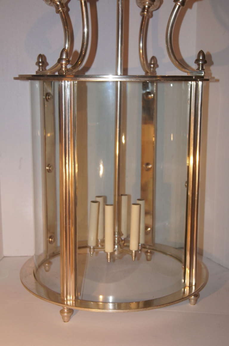 A large, neoclassic style, circa 1930 silver plated lantern with bent glass panels and with six interior lights.