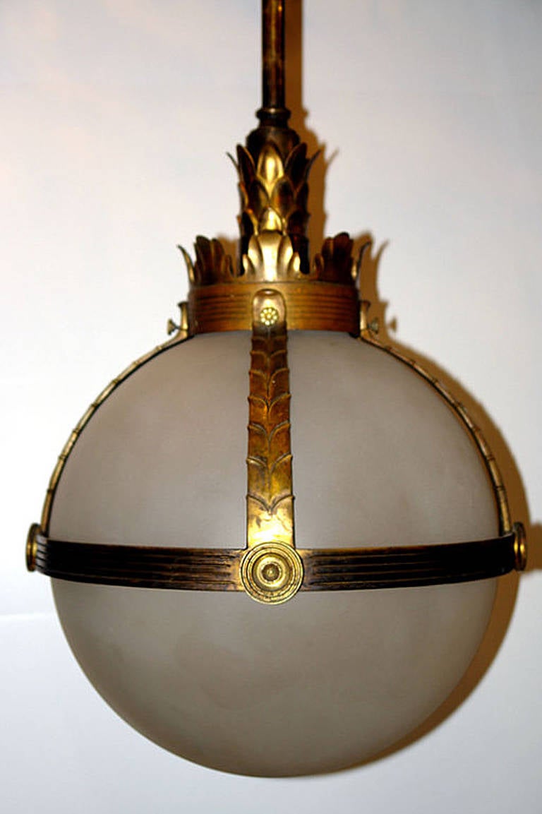 An American, neoclassic style cast bronze lantern with frosted glass globe and interior light.

Height: 30