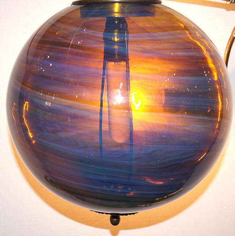 A circa 1960s American art glass light fixture with a single interior light.

Measurements:
Diameter: 12