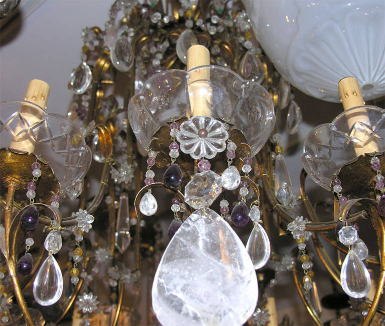 12-light gilt metal chandelier with amethyst and crystal beads, and rock crystal pendants. Original patina.

Measures: Height: 47