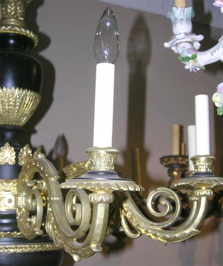 A circa 1920 French Empire style chandelier with ten lights. With foliage and rosette decorations on a tole body. Original finish.

Measure: Height 35