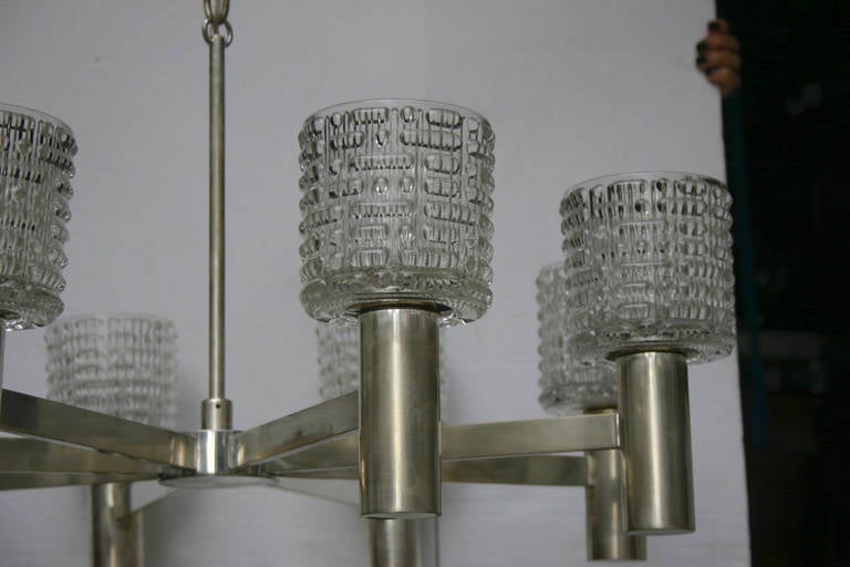 Pair of 1960 Swedish silver plated and molded glass chandeliers with 8 lights each.  
 
Measurements:
32