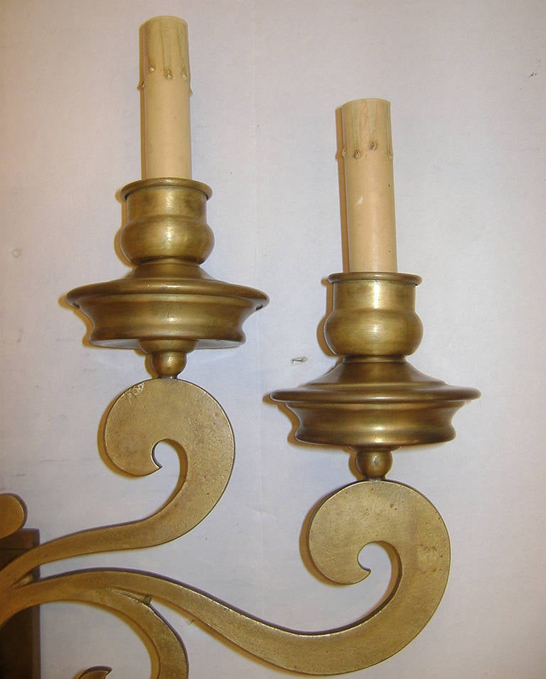 A set of eight, circa 1950, Italian bronze sconces with four lights each. Scrolling motif on body. 
Measurements:
19