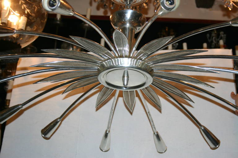 An Italian silver plated light fixture, in the shape of sunburst, and with 14 lights,  circa 1960.

Measurements:
13 3/4