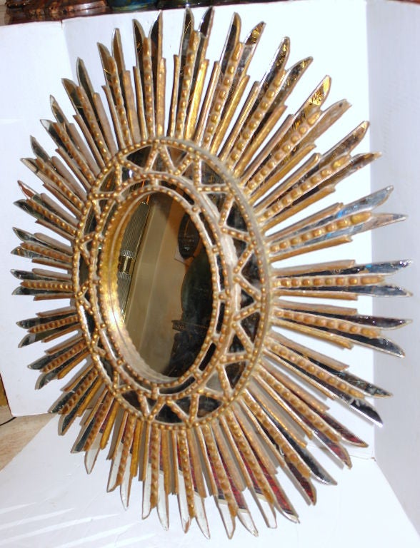 A circa 19th century Spanish giltwood sunburst mirror with mirror insets.

Measurements:
Height 39
