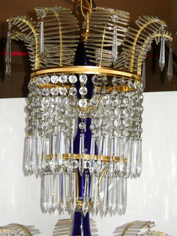 A gilt bronze neoclassic chandelier with cobalt blue glass body and crystal pendants.
Nine lights.

Measures: 30